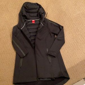 Nike lightly lined hooded, zippered jacket.  Hits thigh.  Zippered pockets.